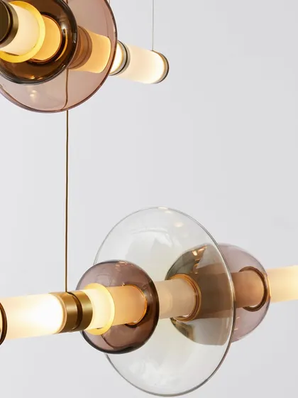 A detailed shot of the Luna series reveals the interplay of colored, transparent, and translucent glass shapes with polished brass hardware. This image emphasizes the rich materials and artisanal quality I select for my collections.