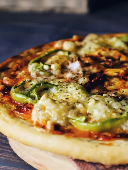 A close-up shot of the pizza, focusing on the melted cheese and crispy crust. This angle is all about making the food look as appetizing as possible.