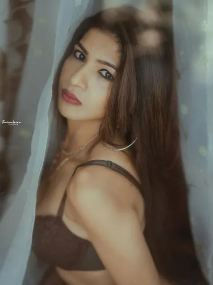 The reflection on the glass adds a layer of complexity to this portrait, making it feel more artistic and less direct.