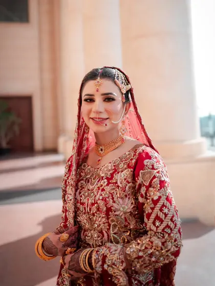 A happy, smiling bridal portrait. The bride is looking directly at the camera, her joy radiating in the bright, natural light.