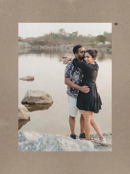 A romantic portrait of the couple by a lake, framed with a textured, artistic border.