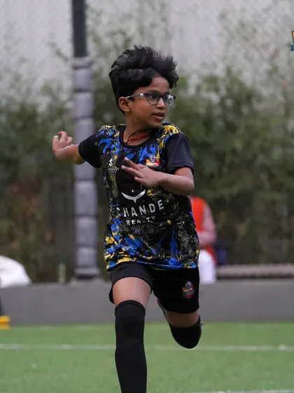 Determination in every stride. A young player with glasses sprints with full focus, proving that dedication and hard work are what truly define a player.