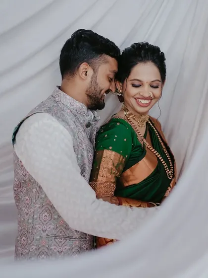 A soft and dreamy portrait of Ameya and Akshata, with a white curtain creating a beautiful, ethereal frame around them.