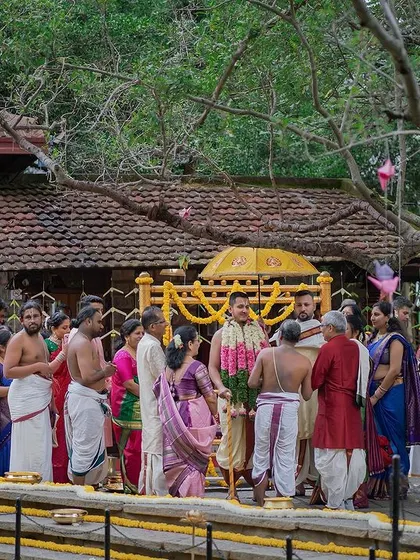 A wide shot of a wedding ceremony taking place at the Pond Pavilion, with guests seated on the steps of the Kalyani.