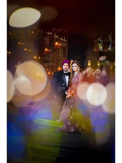 An artistic shot of the couple using a prism to create a beautiful bokeh effect. This technique adds a dreamy and magical quality to their reception portrait.