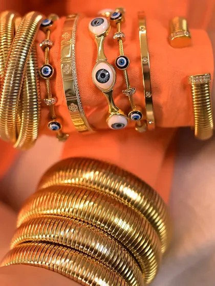 This is how you create a statement stack. A bold combination of my chunky layered twisted bangles and various evil eye bracelets.