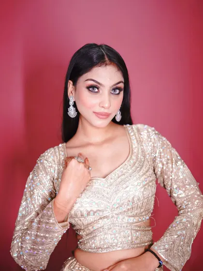 A close-up of the golden lehenga's blouse, showing the detailed sequin work.