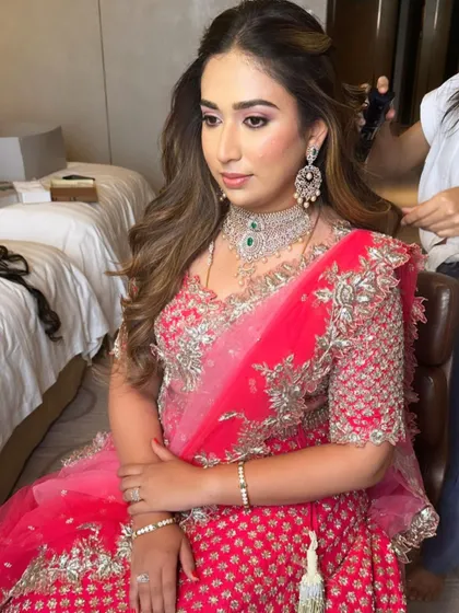 A behind-the-scenes moment of getting this client ready for her event in a stunning pink lehenga.