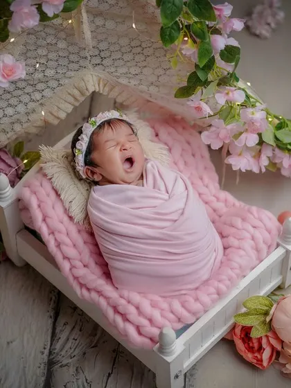 The tiniest yawn in a bed of flowers. Capturing these sleepy, candid moments is just as important as the posed shots. It's all part of their story.