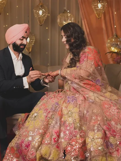 The ring exchange. This beautiful moment is made even more special by their perfectly coordinated Sangeet outfits.