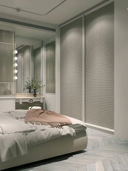 This neo-classical bedroom showcases luxury in pastels. Victorian-style wallpapers in tones of beige, ivory, and hints of dusty peach create a glamorous look, while chevron wood floors in a herringbone pattern add tasteful elegance and warmth.