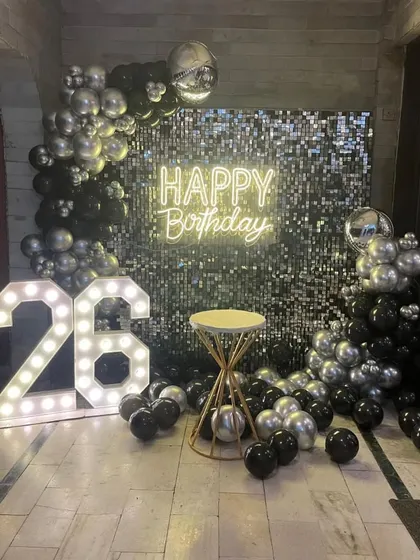 The sequin backdrop with a cake table, ready for the celebration.