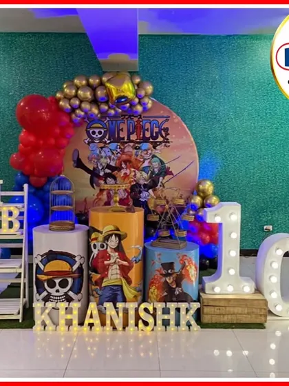 A pirate adventure with a One Piece-themed 10th birthday. The setup includes a character-filled backdrop, themed plinths, and a large light-up number '10'.