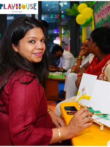 It's not just for the kids! I love it when parents join in on the creative fun. Here, a mother enjoys a quiet moment of painting during an art-themed party, making memories right alongside her child.