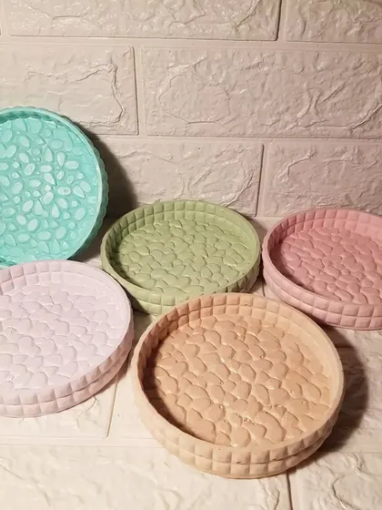 A collection of our round marshmallow trays in various pastel colors. The textured surface is inspired by the look of marshmallows.