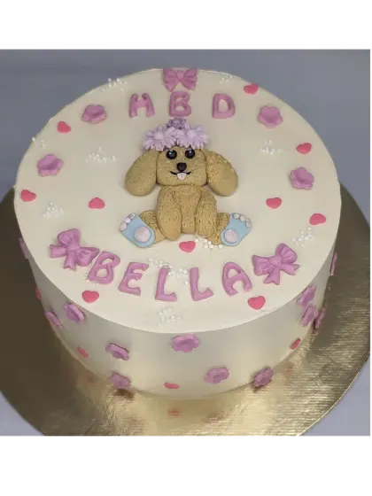 A sweet cake for a pet dog's birthday. This fresh mango cake is decorated with a cute fondant puppy, bows, and hearts.