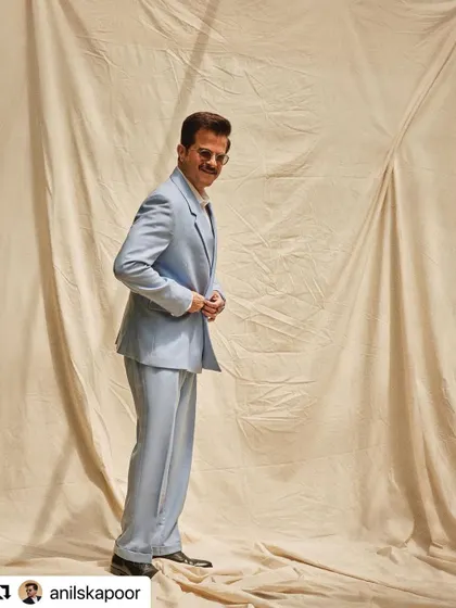 A full-length view of Anil Kapoor's light blue suit look, with hair styled to match the cool, confident vibe.