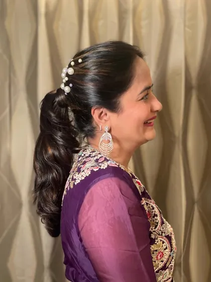 A profile shot of the elegant pearled ponytail.