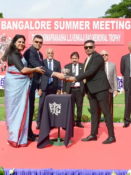 Mr. Bharatram Lokkur presents The Dharmaprakasha L.S. Venkaji Rao Memorial Trophy to the owners of Mayne Magic.