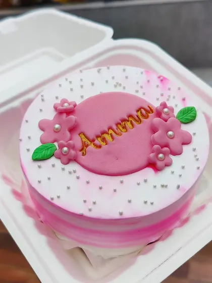A pretty pink bento cake for "Amma". The design features delicate fondant flowers and pearl sprinkles.