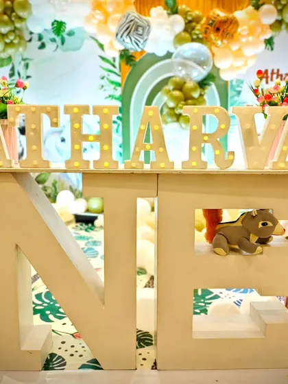 We personalize every party with details like these large marquee letter's spelling out the birthday boy's name, 'Atharva', and a 'ONE' sign for his first birthday celebration.