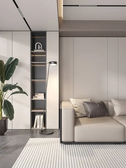 Simplicity and function define this corner. A comfortable sofa is paired with a tall, built-in shelving unit, perfect for displaying books and decor. The addition of a large potted plant and a modern floor lamp makes this a cozy and stylish reading nook.