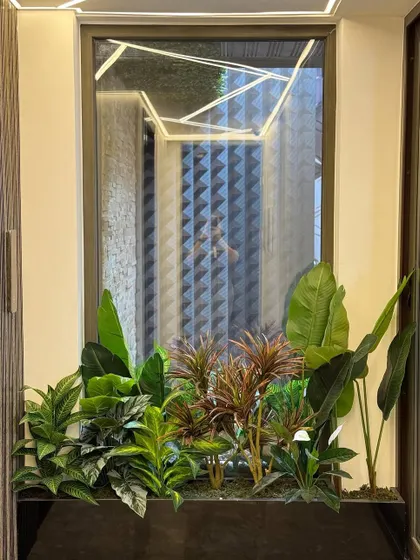 This planter is strategically placed to add greenery beneath a modern, geometric light fixture, creating a cohesive design story that balances hard lines with soft, natural elements.