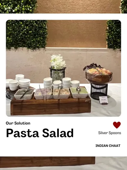 Our Pasta Salad is a refreshing and flavorful option for any buffet. It's prepared with fresh vegetables and a light dressing, served in a large wooden bowl for a rustic touch.