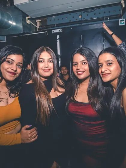 Four friends posing for a photo during a night out. I provide the soundtrack for your good times with friends.