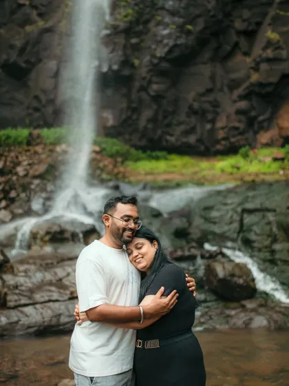 A warm embrace shared by a couple during their waterfall pre-wedding photoshoot.