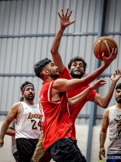Players battling for position under the basket. This photo captures the physicality and competitiveness of our games.