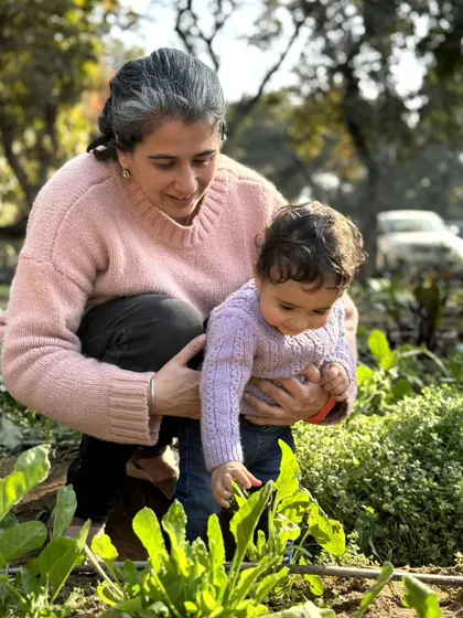 A mother and her baby get up close with the plants. It's a gentle and beautiful way to introduce the youngest members of the family to the farm.