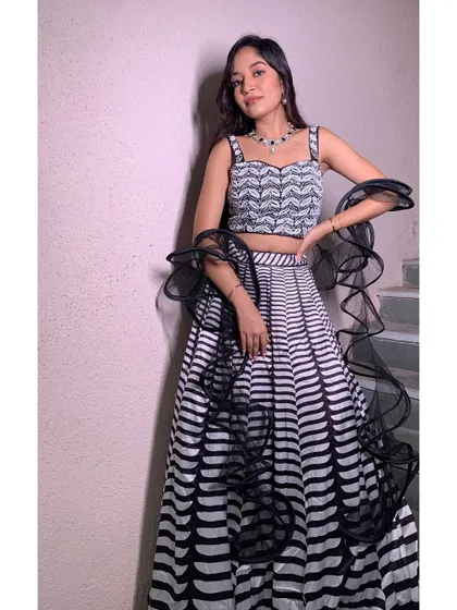 A modern and chic black and white lehenga for a cocktail party. The makeup is kept elegant and sophisticated to match the outfit.