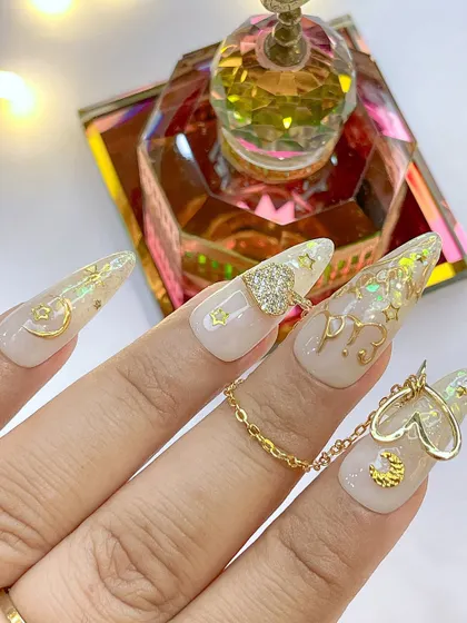 A unique angle of the Eid nail art, showing the chain and heart charm that connect the nails, a technique we teach in our advanced courses.