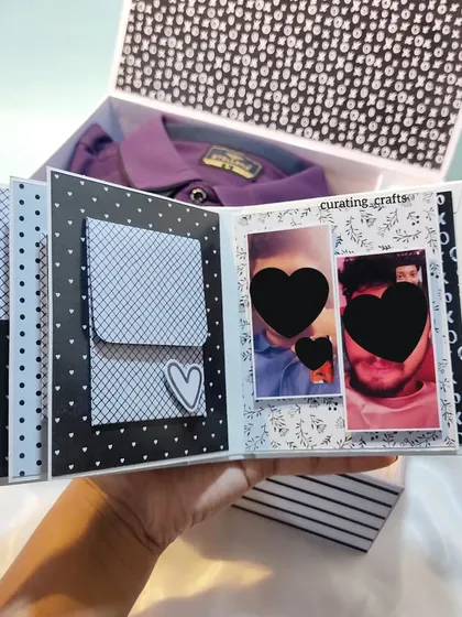 This hamper includes a mini scrapbook and a stylish purple shirt, all in one box.