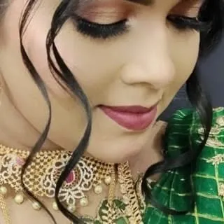 A close-up on the eye makeup, showing perfectly applied false lashes and blended eyeshadow, key skills for any professional makeup artist.