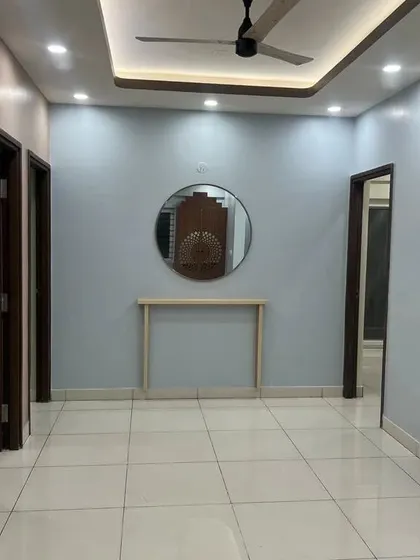 Another view of the empty hall, showing the placement of a console table and mirror, giving a sense of the final layout.