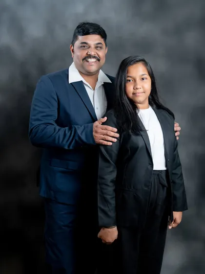 A proud father with his daughter. This classic portrait showcases the strong and protective bond in a simple, powerful way.