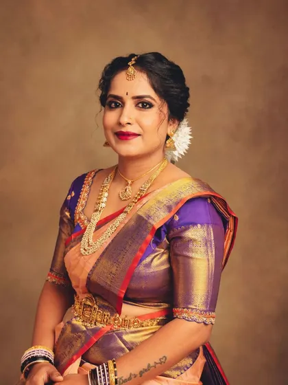 A classic portrait that brings focus to the subject's expression and the upper portion of the attire. The soft lighting highlights the sheen of the silk and the warmth of her smile.