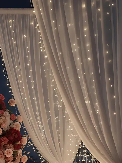 Soft, flowing drapery and curtains of twinkling fairy lights are essential for creating a dreamy, enclosed space. They add a layer of intimacy and magic to any outdoor or large venue.