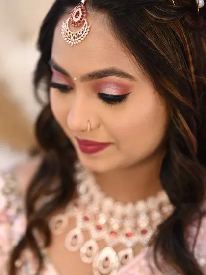 A detailed shot of the eye makeup for this engagement look. The winged eyeliner and shimmery pink shadow create a romantic and defined eye.