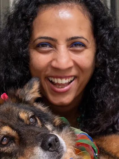 A joyful, close-up shot of a woman and her dog. Her smile says everything about the love she has for her furry friend.