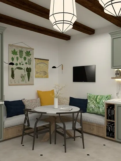 This kitchen design has a classic, farmhouse feel with its sage green cabinets and exposed wood beams. The built-in bench seating creates a cozy breakfast nook right in the heart of the kitchen, perfect for casual family meals.