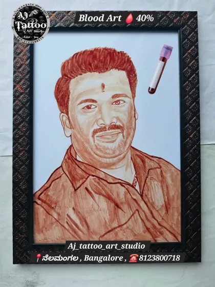 A hand-painted blood portrait of a man, capturing a warm and friendly expression. The vial of blood is shown alongside the art, connecting the medium to the final product.