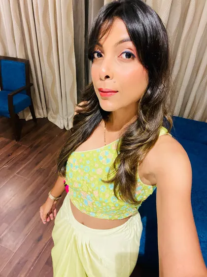 A selfie showing my look for a Sufi night. This is a neon green indo-western outfit with a one-shoulder embroidered top and draped skirt, perfect for a night out.