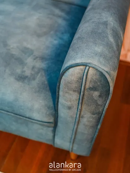 A detail of the sofa's armrest, showing the expert tailoring and piped seams that are a hallmark of my custom upholstery work.