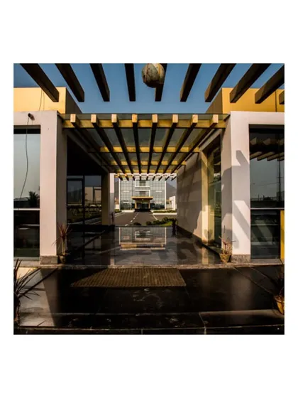 This view from the security block at the KSG campus frames the main administrative building through a pergola structure. This deliberate framing is a technique we use to create layered views and a sense of journey within our architectural layouts.
