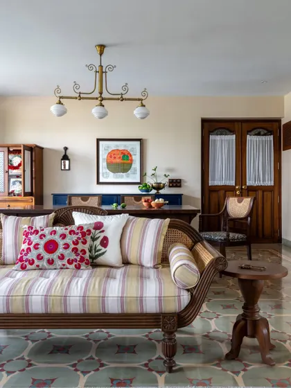 A vintage-style diwan in the Calcutta living room, layered with colorful, embroidered cushions. This piece adds a touch of nostalgia and comfort, a perfect spot for an afternoon nap or a long chat over tea.