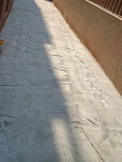 Another view of a prepared base, showing the smooth, hard-packed surface that will sit underneath the synthetic turf.