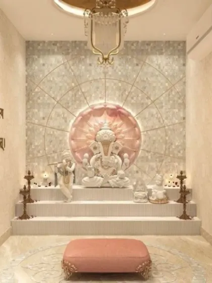 A tranquil pooja room featuring a multi-tiered platform for idols, set against a mother-of-pearl style lotus backdrop. The space is softened with warm lighting, and the walls include engraved Sanskrit shlokas for a complete spiritual experience.
